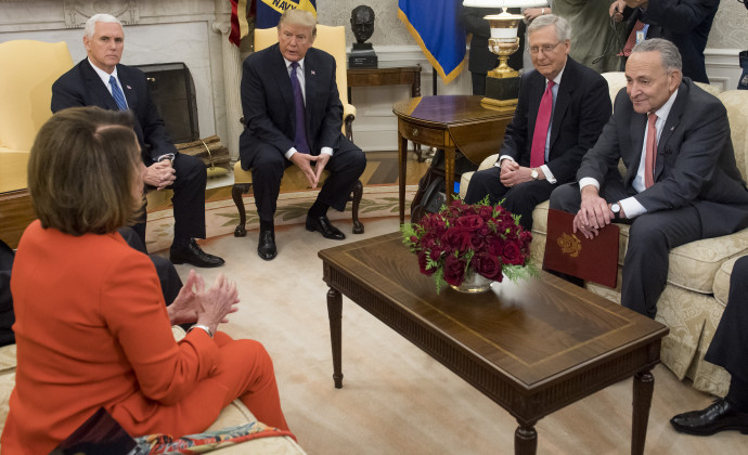 US President Donald Trump, alongside Vice President Mike Pence (2nd L), meets with Congressional leadership including Senate Majority Leader Mitch McConnell (2nd R), Republican of Kentucky, Senate Minority Leader Chuck Schumer (R), Democrat of New York, and House Democratic Leader Nancy Pelosi (L), Democrat of California, in the Oval Office at the White House in Washington, DC, December 7, 2017. (Photo by SAUL LOEB / AFP)