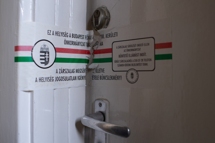 A kormányhivatal zárszalagja az egyik lakás ajtaján – Fotó: Bődey János / Telex