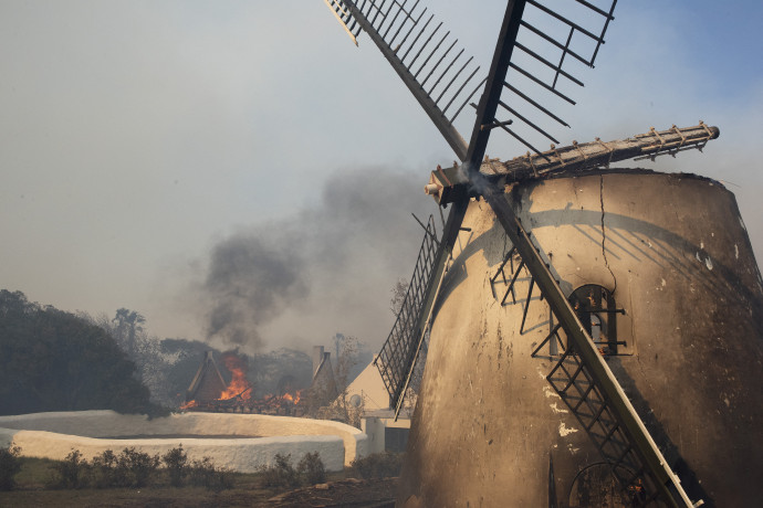 A leégett szélmalom (fent) és a könyvtár épületét oltó tűzoltók (lent) – Fotó: Rodger Bosch / AFP