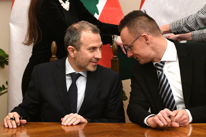Lebanese Foreign Minister Gebran Bassil (L) and Hungarian Trade and Foreign Minister Peter Szijjarto (R) chat before a signing ceremony of a diplomatic cooperation agreement between their countries at the Trade Minstry in Budapest on November 26, 2019. (Photo by Attila KISBENEDEK / AFP)