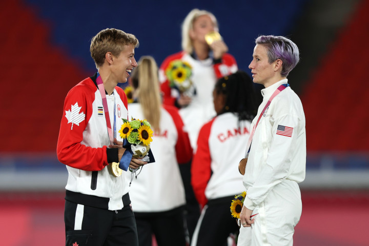 Az aranyérmet szerzett kanadai csapat transznemű középpályása, Quinn beszélget az bronzérmes amerikai Megan Rapinoe-val 2021. augusztus 6-án a Jokohama Nemzetközi Stadionban. Rapinoe évek óta nyíltan vállalja melegségét és az LMBTQI-közösség aktivistája – Fotó: Naomi Baker/Getty Images