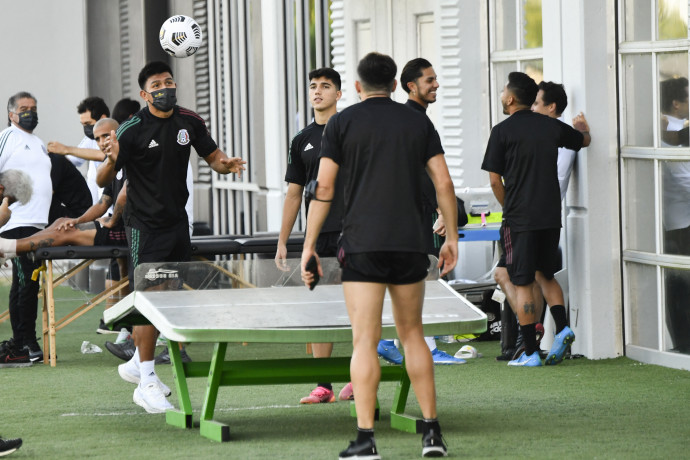 Mexico soccer men's national team members play Teqball – ping pong played with a soccer ball – prior to a training session before their CONCACAF Gold Cup semifinal football match on July 28, 2021 at Houston Sports Park in Houston, Texas. (Photo by Patrick T. FALLON / AFP)