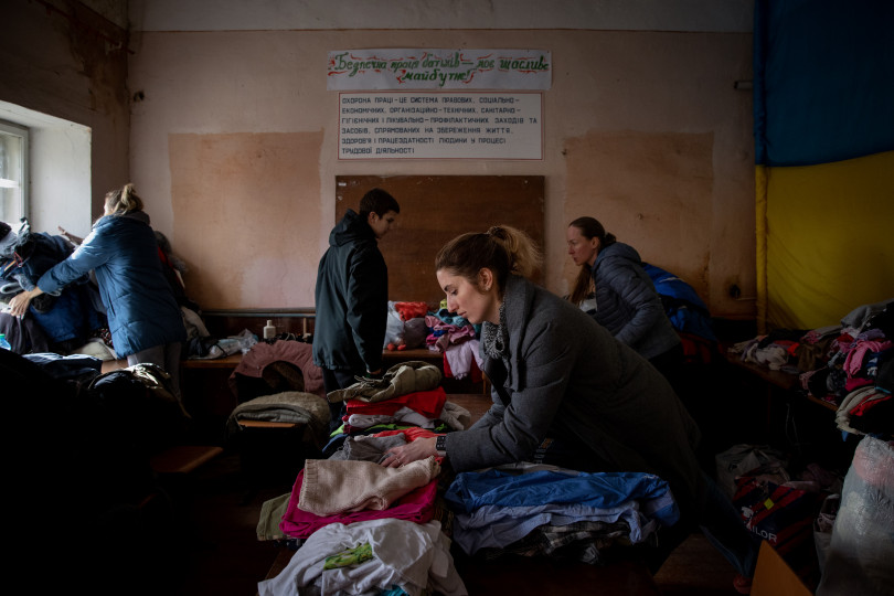 Internal refugees from Kyiv are leaving for their temporary accomodation with some blankets and warm clothing.