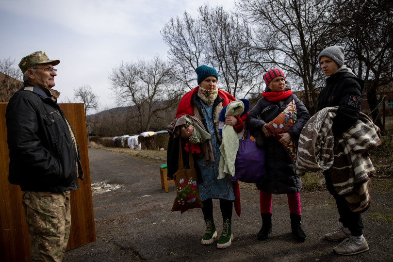 Internal refugees from Kyiv are leaving for their temporary accomodation with some blankets and warm clothing.