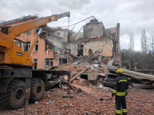 Ágyúzás során megrongálódott iskolaépületet bontanak Csernyihiv városban 2022. március 7-én – Fotó: STR / AFP