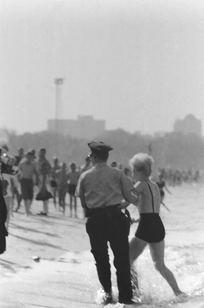 Rendőr kíséri el a chicagói Tony Lee Shellyt, miután a Michigan-tó partján lévő North Beachen topless fürdőzött 1964. június 20-án. Tony úgy nyilatkozott, hogy semmilyen illetlen dolgot nem talál az emberi testben, mégis letartóztatták azzal a váddal, hogy nem megfelelő öltözékben fürdőzött – Fotó: Bettmann / Getty Images