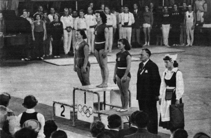 "The second gold medal. Ágnes Keleti at the top of the podium." Photos: Arcanum / Sándor Barcs: Victory in Helsinki, 6. December 1952 (Published by: Ifjúsági Könyvkiadó)