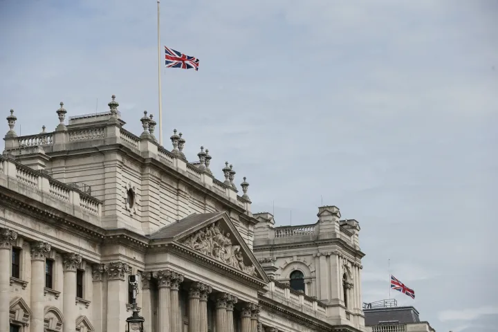 Zászlók lobognak félárbócra eresztve a kormányépületek felett a Whitehallon London központjában – Fotó: Daniel Leal / AFP