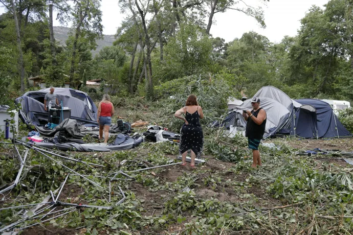 A korzikai Sagone kempingben emberek szedik össze megmaradt holmijaikat és sátraikat. A kempingben egy fa egy bungalóra dőlt, és egy embert megölt 2022. augusztus 18-án – Fotó: Pascal Pochard-Casabianca / AFP 