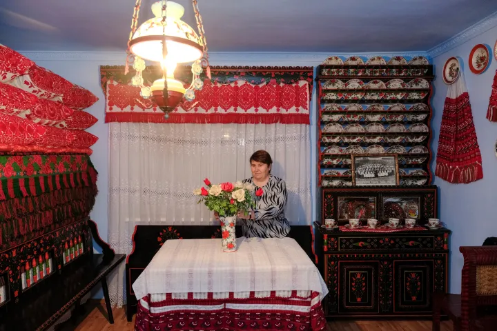 Sára Nagy shows us one of her rooms in Sic, including her bridal goods and needlework. She notes modestly that for the women of Sic, it was a disgrace 'if they didn't keep their hands busy with some sort of work.' – Photo by Tamás Márkos / Transindex / Telex