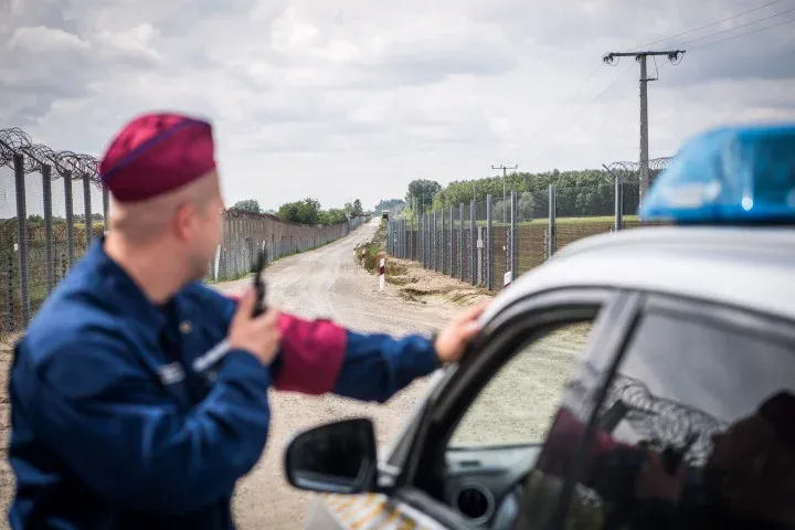 On the photo published by the Prime Minister's Office, a police officer is patrolling along the fence at Hungary's border with Serbia on 1 September 2021 – Photo: Szabolcs Vadnai / Prime Minister's Office / MTI