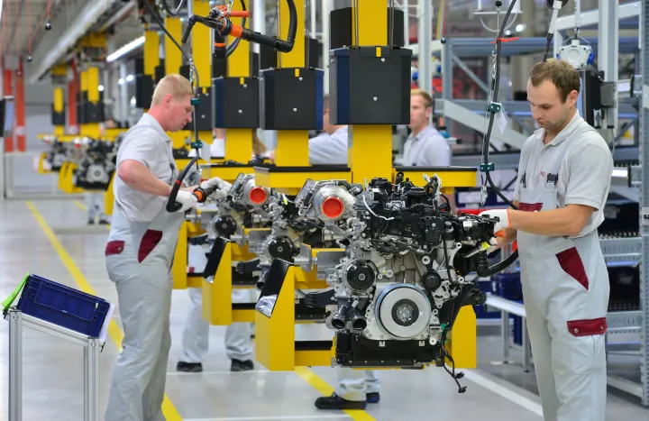Munkások négyhengeres dízelmotorokat szerelnek a Daimler motorgyárában, a németországi Kelledában, 2015 októberében – Fotó: Martin Schutt / DPA / Getty Images