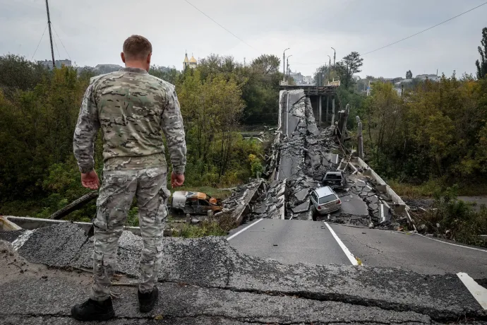 Ukrán katona áll egy felrobbantott felüljárónál Kupjanszkban – Fotó: Huszti István / Telex