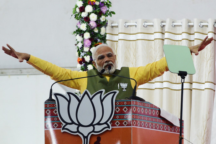 Indian Prime Minister Narendra Modi gestures as he speaks during a Bhartiya Janta Party (BJP) rally ahead of 2nd phase of Gujarat's assembly election, in Ahmedabad on December 2, 2022. (Photo by SAM PANTHAKY / AFP)