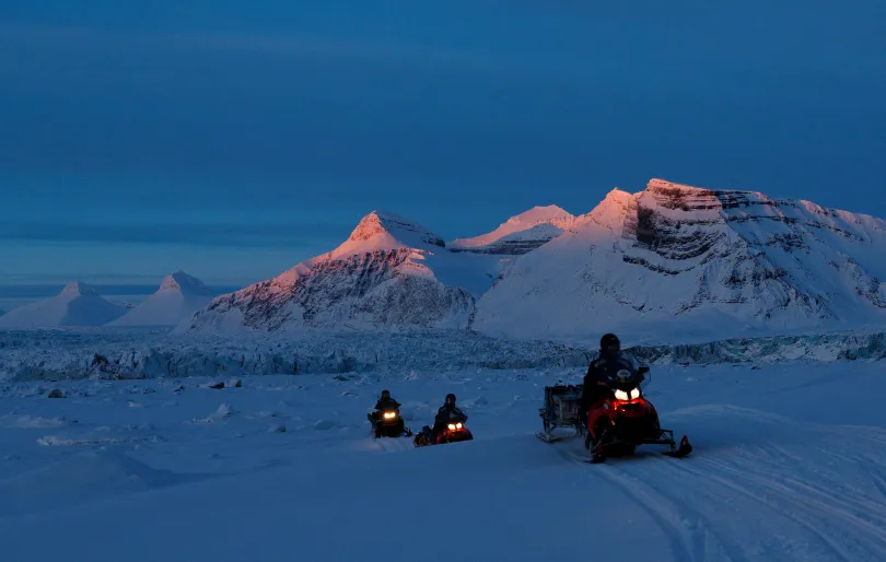 A Norvég Sarkvidéki Intézet tudósai motoros szánon hajtanak hazafelé, miközben a nap lenyugszik a Kongsfjord és a Kronebreen gleccser partján, Ny-Aalesund közelében. Házak Ny-Aalesund városában, a norvégiai Svalbard-szigeteken – Fotók: Lisi Niesner / Reuters
