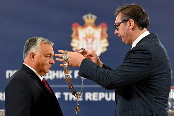 Serbian President Aleksandar Vucic (R) presents the Order of Merit of the Republic of Serbia to Hungarian Prime Minister Viktor Orban during their meeting in Belgrade on September 16, 2022. During the Hungarian Prime Minister's one day visit, The Serbian President will present to him the Order of Merit of the Republic of Serbia, “in recognition of his outstanding services in developing and strengthening peaceful cooperation and friendly relations between Serbia and Hungary”. (Photo by ANDREJ ISAKOVIC / AFP)