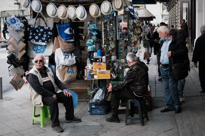 Turisták egy kioszk kínálatát nézik Athénban – Fotó: Nikolas Kokovlis / AFP