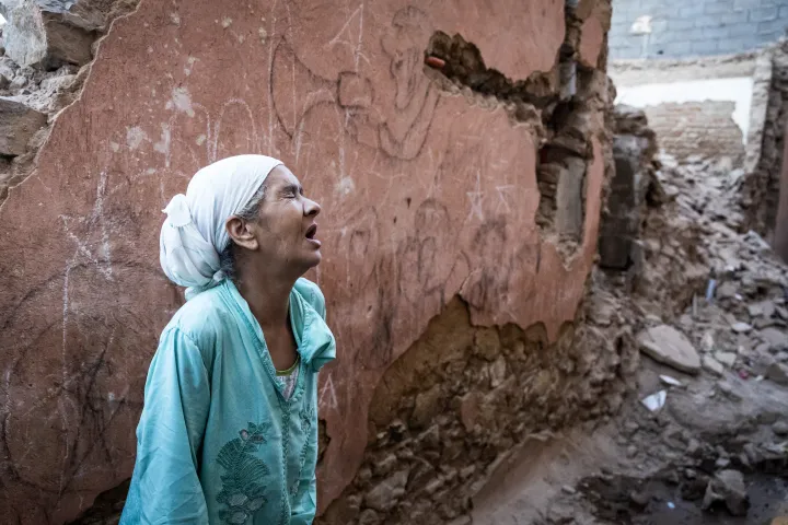 A földrengést túlélő nő romba dőlt háza előtt – Fotó: Fadel Senna / AFP 