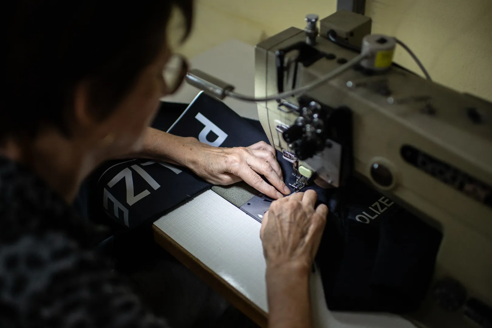 A seamstress prepares a police jacket at the Pletex Doo sewing facility in Ada, Vojvodina – Photo: János Bődey / Telex