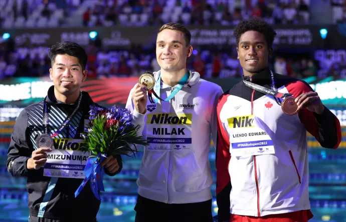 A japán ezüstérmes Naoki Mizunuma, az aranyérmes Kristof Milak és a kanadai bronzérmes Joshua Liendo Edwards a férfi 100 méteres pillangóúszás döntője után a budapesti FINA Világbajnokságon, a Duna Arénában 2022. június 24-én – Fotó: Ian MacNicol / Getty Images