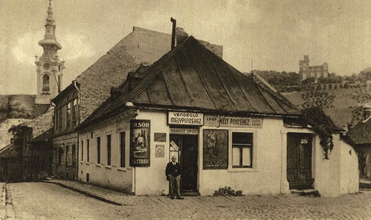 A Mély Pince vendéglő, 1920-as évek. A bejárat előtt Krausz Poldi (Lipót) – Fotó: Képes levelezőlap / Tabán – fényképek, történetek