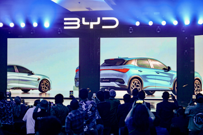 Journalists record video using their smart phone during the launch of the Chinese-made BYD brand in Jakarta, on January 18, 2024, and at the same time introduced 3 types of battery-powered vehicles (EV, electric vehicle) that will be sold in Indonesia, with an investment of 1.3 billion US dollars. (Photo by BAY ISMOYO / AFP)