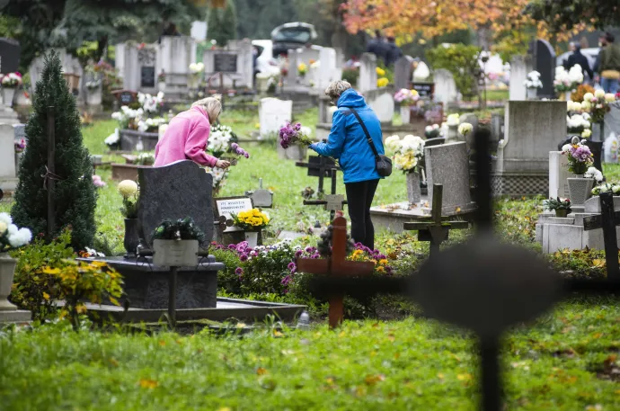 Hozzátartozók virágot visznek egy sírra Nyíregyházán, az Északi temetőben mindenszentek ünnepe és halottak napja előtt, 2022. október 30-án – Fotó: Balázs Attila / MTI