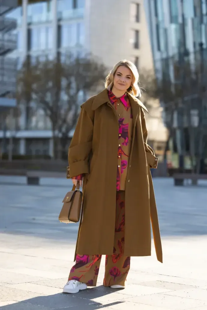 Zsófia Jakab, Ministerial Commissioner for the Development and Coordination of the Creative Industries at the Ministry of National Economy and CEO of the Hungarian Fashion & Design Agency, wearing pieces by Hungarian designers (Tomcsányi pants and top, a Daige coat, and a Nini bag) at the Budapest Central European Fashion Week on February 5, 2023 – Photo: Matt Jelonek / Getty Images