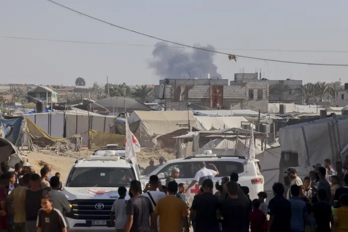 Palesztinok figyelik Kán Júniszban, ahogy a Hamász emberei átadják a Vöröskeresztnek az általuk megtalált izraeli holttesteket 2025. október 26-án – Fotó: Abdelrahman Rashad / Middle East Images / AFP