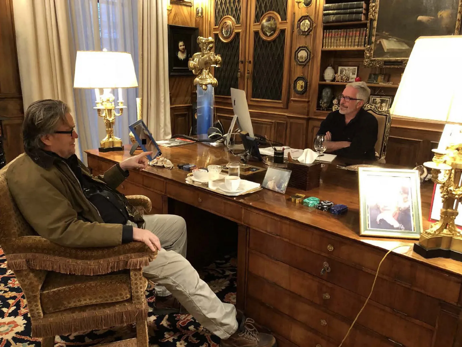 Több részletben elkezdték nyilvánosságra hozni az Egyesült Államokban a kiskorú lányok szexre kényszerítésével vádolt, majd öngyilkosságot elkövetett Jeffrey Epsteinről szóló aktákat. A demokraták szerint Donald Trump elnöknek is kitüntetett hely jut a képekkel és más dokumentumokkal tűzdelt aktákban. A fotón Jeffrey Epstein beszélget Steve Bannon republikánus stratégával, podcasterrel azonosítatlan helyen és időben – Fotó: House Oversight Democrats / AFP