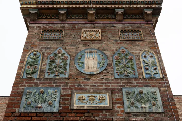 Cifra kémény a pécsi Zsolnay kulturális negyed Pirogránit udvarán, középen a Pécset jelképező öt tornyot ábrázoló Zsolnay embléma – Fotó: Bődey János / Telex