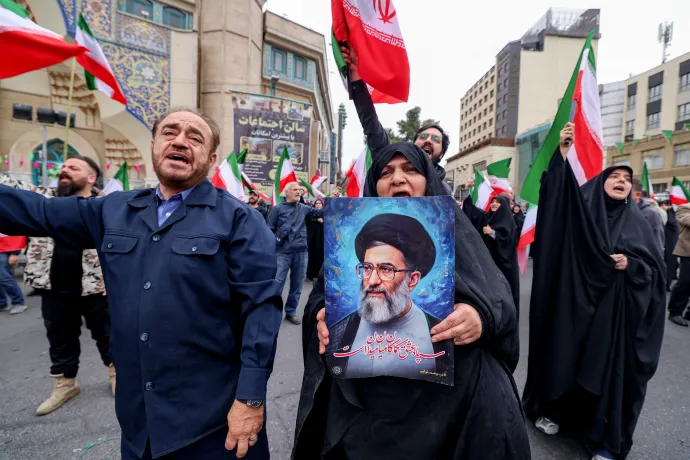 Iráni asszony Ali Hamenei ajatollah portréjával demonstrál a rezsim mellett egy teheráni mecset előtt 2026. február 28-án, az izraeli és az amerikai hadsereg Irán elleni légicsapásai után. Fotó: Atta Kenare / AFP